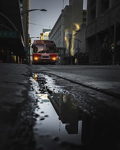 red and white truck beside building thumbnail