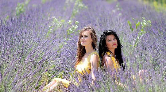 two women sittings on purple flowering garden thumbnail