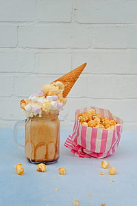 ice cream beside popcorn on blue surface thumbnail