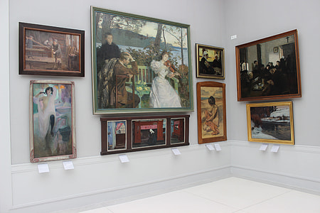 assorted framed paintings on white wall thumbnail
