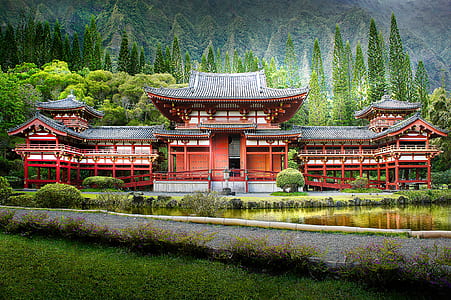 red temple surrounded with trees during daytime thumbnail