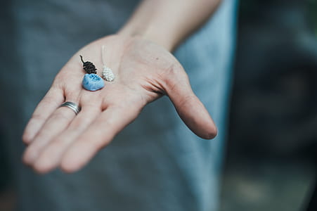 person holding ornaments thumbnail