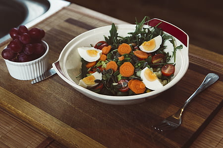 vegetable salad in round white ceramic bowl on top of brown wooden tray thumbnail