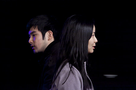 man in black shirt beside woman in gray jacket thumbnail