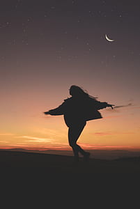silhouette of a woman running during night thumbnail
