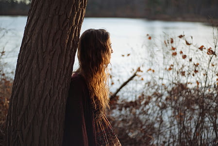 woman in brown long-sleeved dress thumbnail
