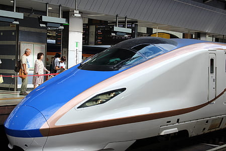 white and blue express train on station thumbnail