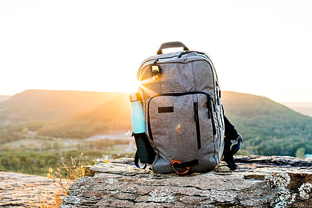 selective focus photography of gray backpack on cliff thumbnail