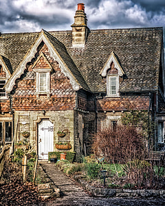 gray and brown house surrounded with grasses thumbnail