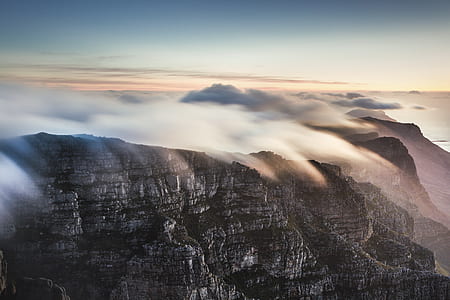aerial photo of gray mountain with clouds at daytime thumbnail