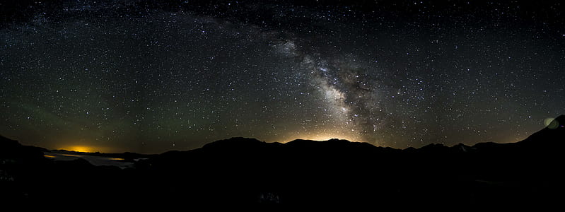 silhouette of mountain under starry sky thumbnail