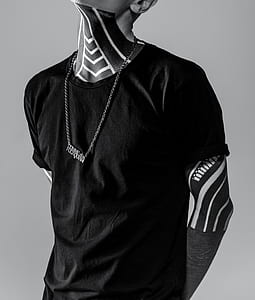 man in black shirt wearing silver-colored necklace thumbnail
