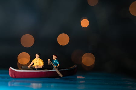 two men in canoe figurine thumbnail