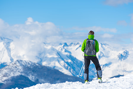 man in green jacket standing on mountain during daytime thumbnail