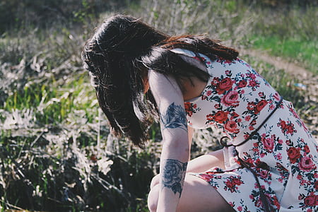 woman looking down on grass thumbnail