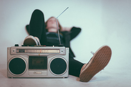 selective focus photography of person stepping on transistor radio thumbnail