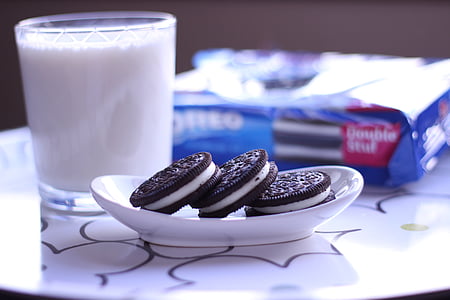 three Oreo cookies on white ceramic saucer plate thumbnail