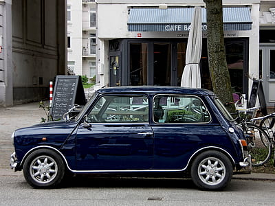 blue 3-door hatchback parked near black tree thumbnail