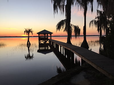 dock on body of water during sun set thumbnail