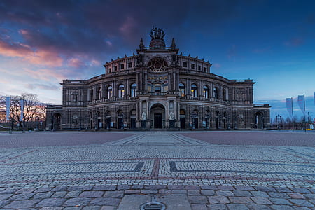 brown building under cloudy sky thumbnail