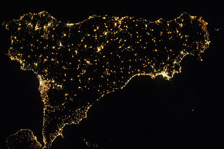 different parts of island with lights during nighttime aerial photography thumbnail