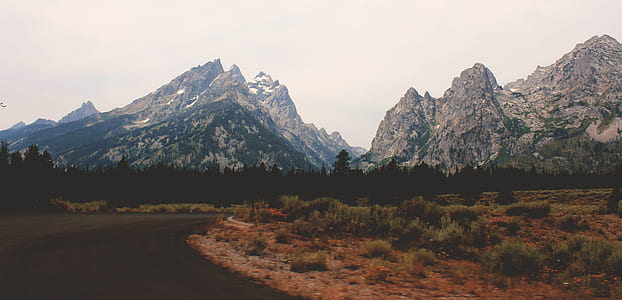 green grass near mountain thumbnail