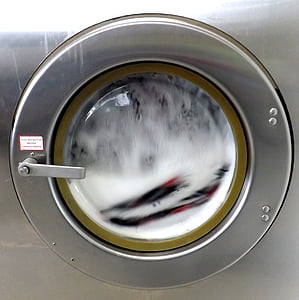 turned-on silver front-load clothes washer thumbnail