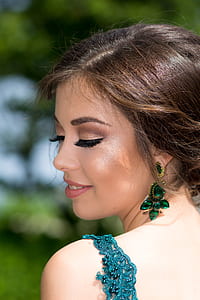 woman wearing blue top near tree thumbnail