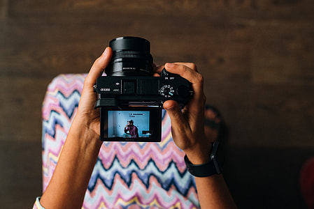 person holding black SLR camera thumbnail