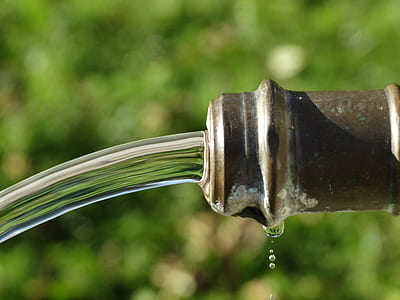 brown metal pipe tube with running water during daytime thumbnail
