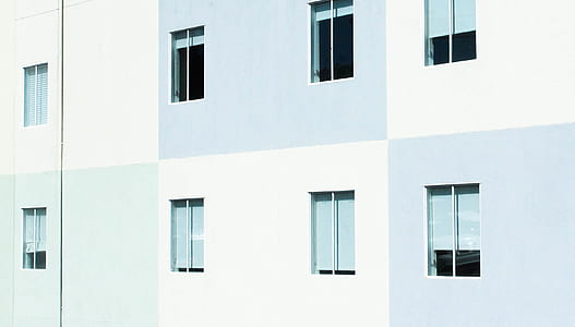 white and gray painted building with glass windows thumbnail