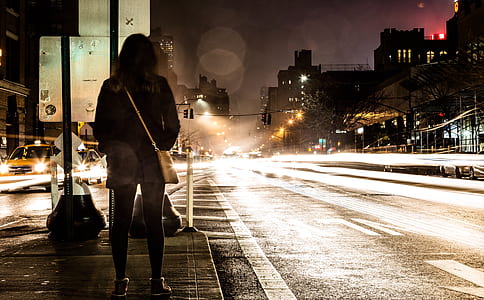 woman standing beside road thumbnail