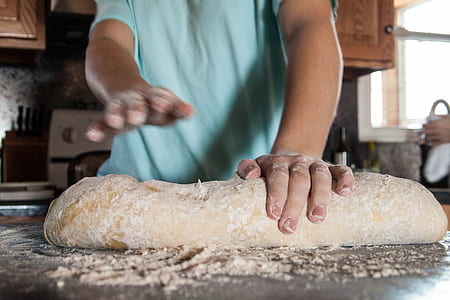 person kneading dough on the table thumbnail