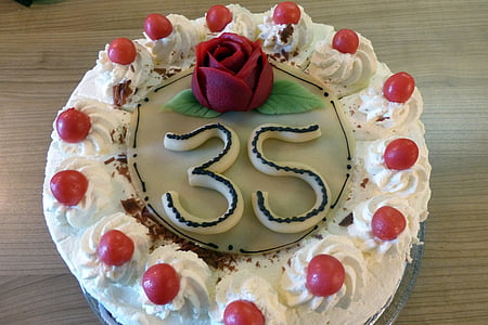 round cake with with and red icing thumbnail