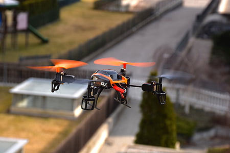 black and orange quadcopter hovering in the air thumbnail
