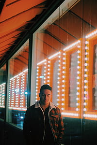 man standing near glass wall thumbnail