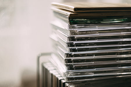 selective focus photograph of CD cases thumbnail