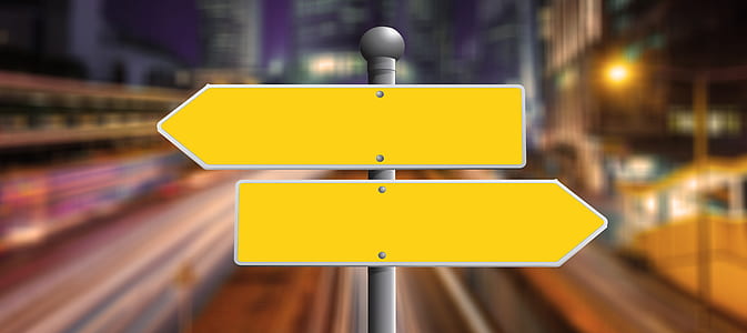selective focus photography of two yellow arrow signages thumbnail