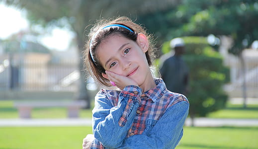 girl in blue denim long-sleeved top standing outside thumbnail