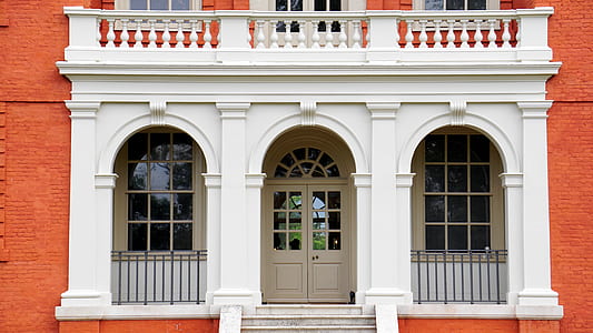 brown wooden door on white concrete infrastructure thumbnail