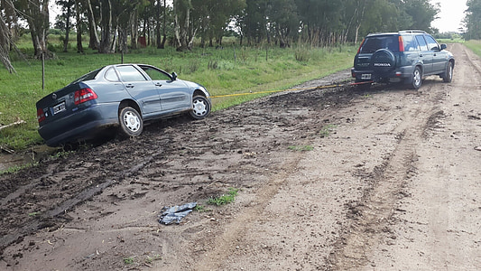 gray sedan on dirt road near gray SUV thumbnail