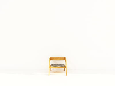 brown wooden framed padded chair beside white wall thumbnail