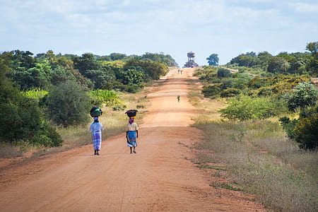 woman walking on pathway during daytime thumbnail