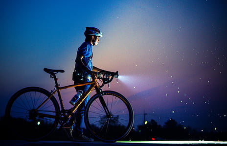photo of man wearing blue top holding brown rigid road bike thumbnail