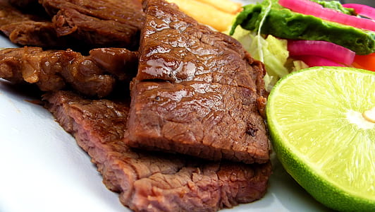 steak beside sliced citrus fruit thumbnail
