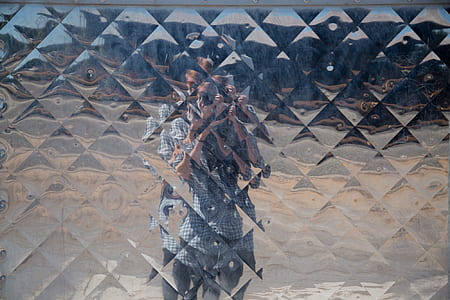 mirror with reflection of a man in front taking picture thumbnail