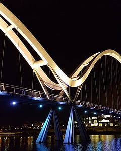 gray and black concrete bridge at night thumbnail
