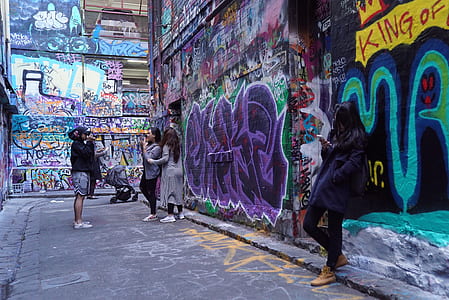 woman leaning at wall with graffiti artwork thumbnail