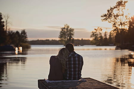man and woman sitting on dock thumbnail
