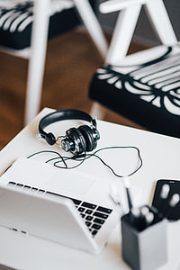 White laptop with smartphone and headphones thumbnail